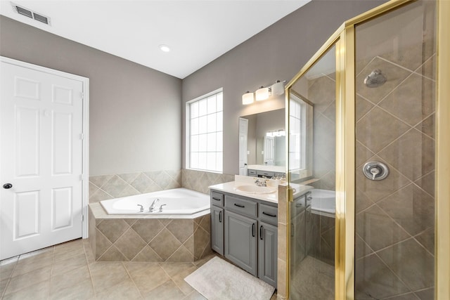 bathroom with tile patterned floors, vanity, and separate shower and tub