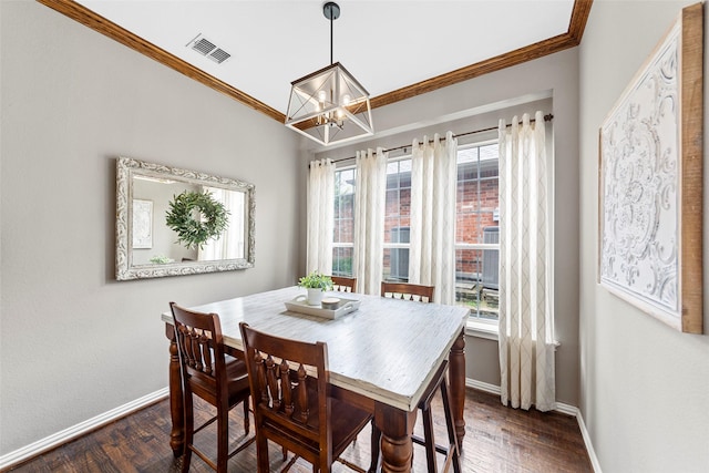 dining room with ornamental molding, dark hardwood / wood-style floors, and a notable chandelier