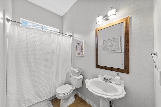 bathroom with sink, tile patterned floors, and toilet