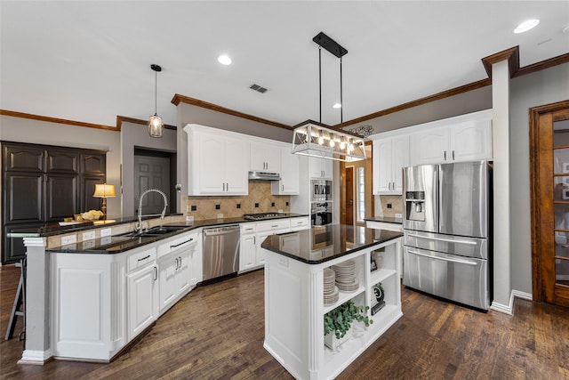 kitchen with a kitchen island, white cabinetry, appliances with stainless steel finishes, and decorative light fixtures