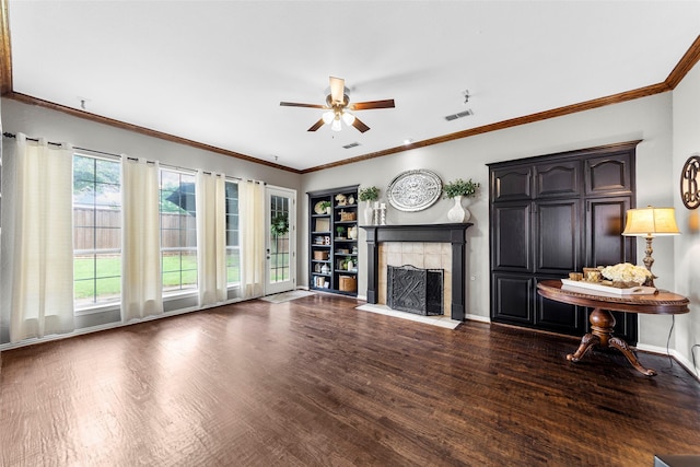 unfurnished living room featuring ceiling fan, a fireplace, ornamental molding, and dark hardwood / wood-style flooring