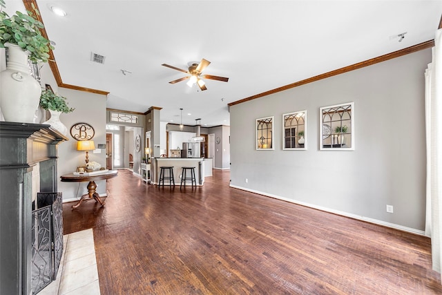 living room featuring ceiling fan, ornamental molding, and hardwood / wood-style floors