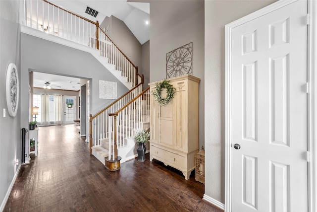 entrance foyer with a high ceiling and dark hardwood / wood-style flooring