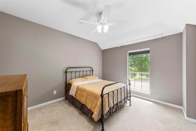 carpeted bedroom with vaulted ceiling and ceiling fan