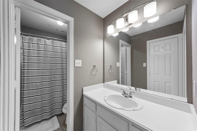 bathroom featuring a shower with curtain, vanity, and toilet