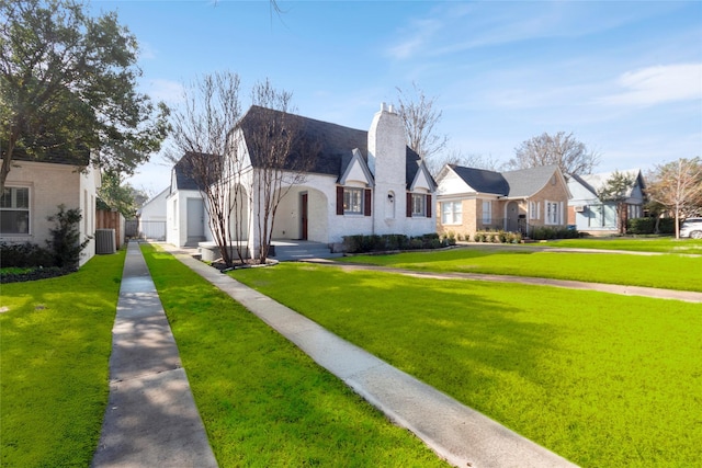 view of front of property with central AC and a front yard