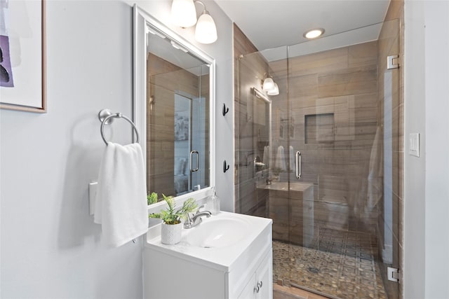 bathroom with vanity and a shower with shower door