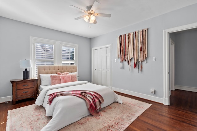 bedroom featuring dark wood-type flooring, ceiling fan, and a closet