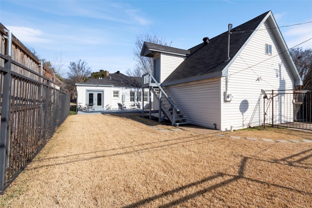 back of property featuring a yard and a patio area