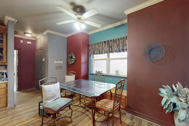 dining room with ceiling fan, ornamental molding, and light hardwood / wood-style flooring