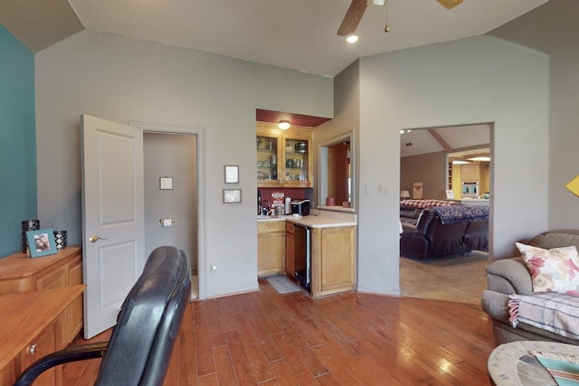 home office featuring lofted ceiling, ceiling fan, and light wood-type flooring