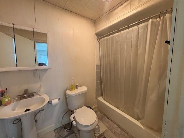 bathroom with shower / bath combination with curtain and toilet