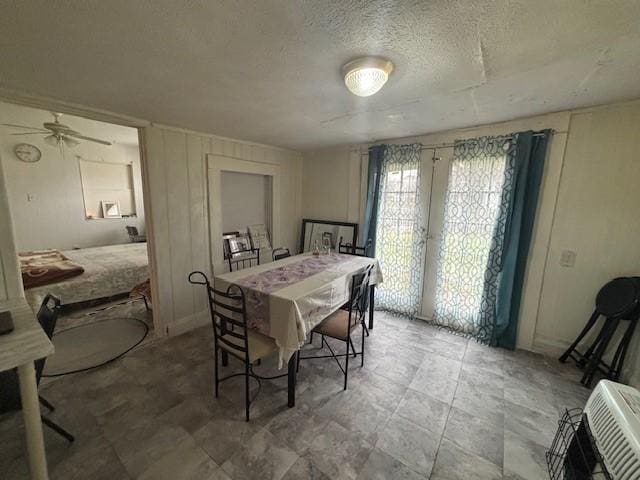 dining space featuring french doors and a textured ceiling