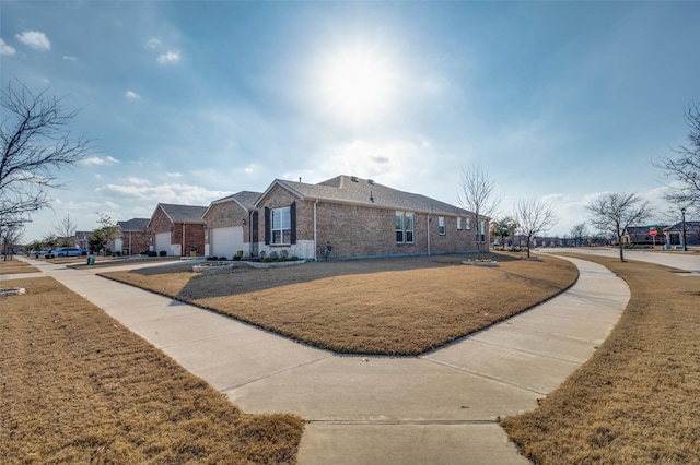 view of front of home with a front yard and brick siding