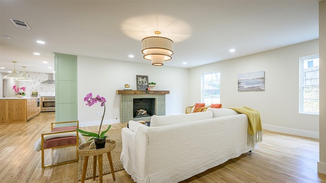 living room featuring a fireplace and light hardwood / wood-style flooring