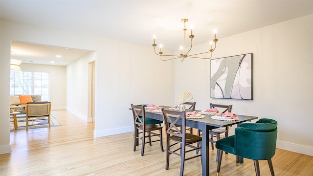 dining area featuring a chandelier and light hardwood / wood-style flooring