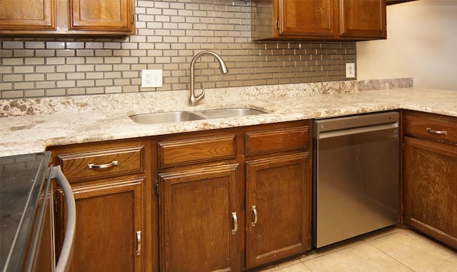 kitchen with sink, stove, backsplash, light tile patterned flooring, and stainless steel dishwasher