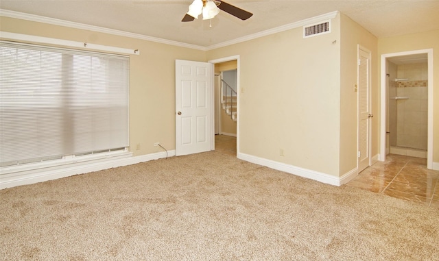 carpeted spare room with ornamental molding and ceiling fan