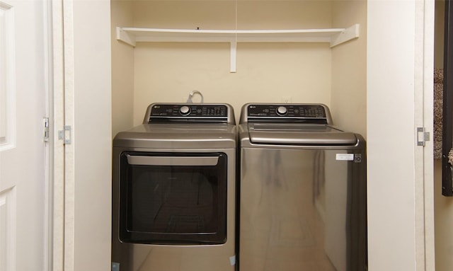 clothes washing area featuring washer and dryer