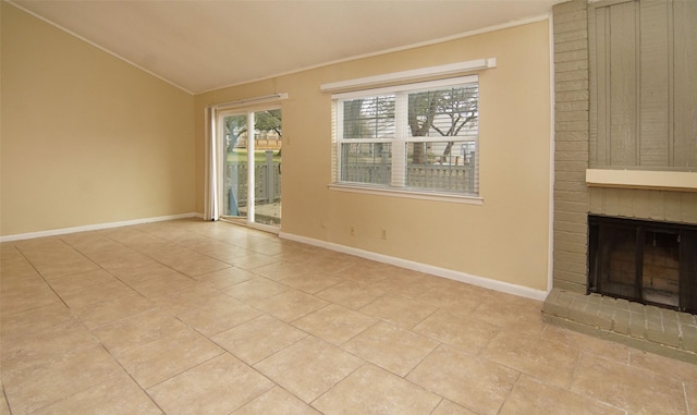 unfurnished living room featuring lofted ceiling, a fireplace, and light tile patterned flooring