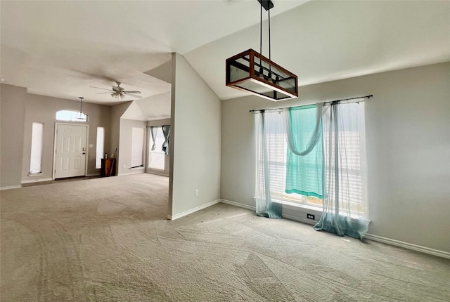 interior space with lofted ceiling, a wealth of natural light, and ceiling fan