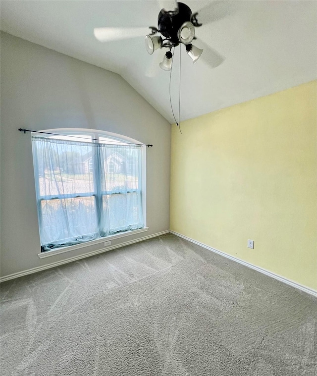 carpeted spare room with vaulted ceiling and ceiling fan