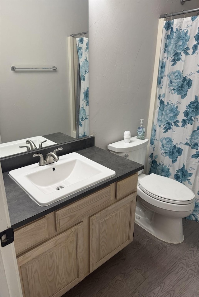 bathroom featuring vanity, toilet, and wood-type flooring