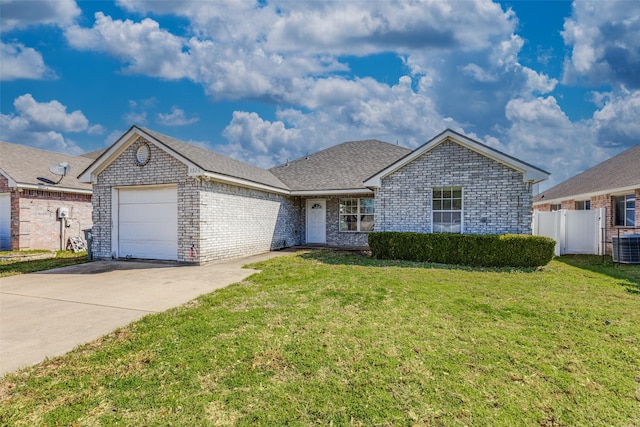 ranch-style home with a garage, brick siding, fence, driveway, and a front lawn