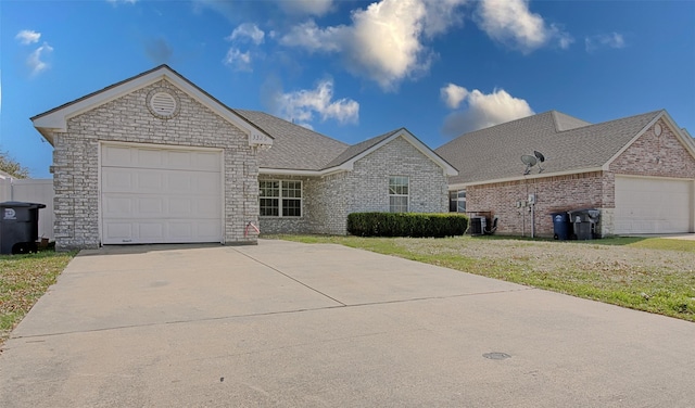 view of front of property with a garage and a front lawn