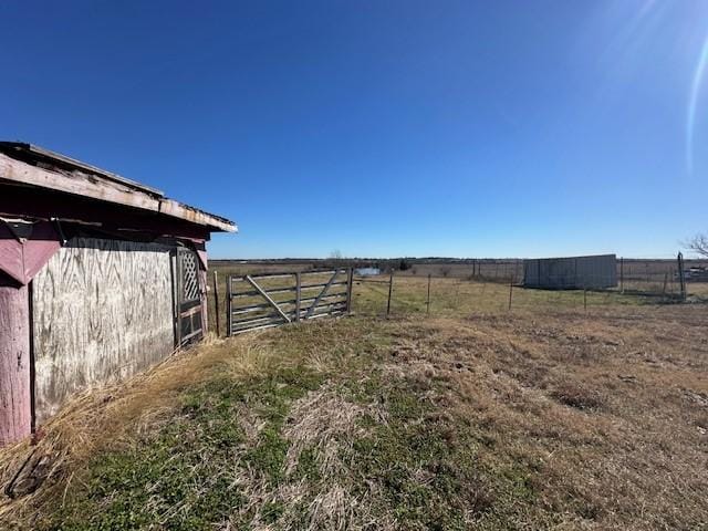 view of yard with a rural view