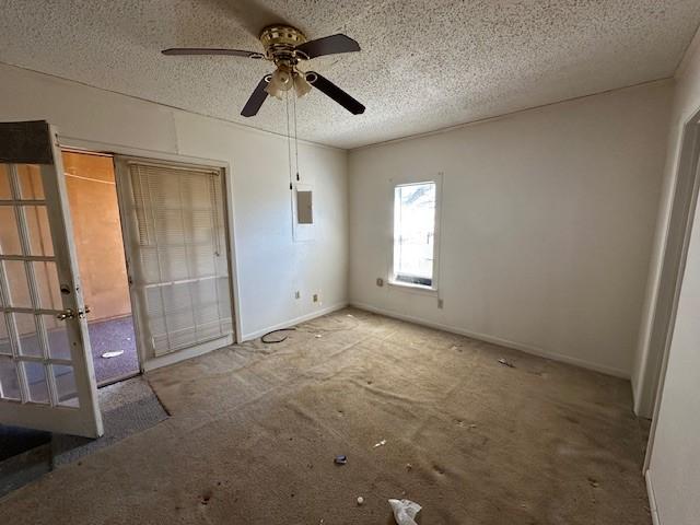 unfurnished bedroom featuring ceiling fan, carpet floors, and a textured ceiling