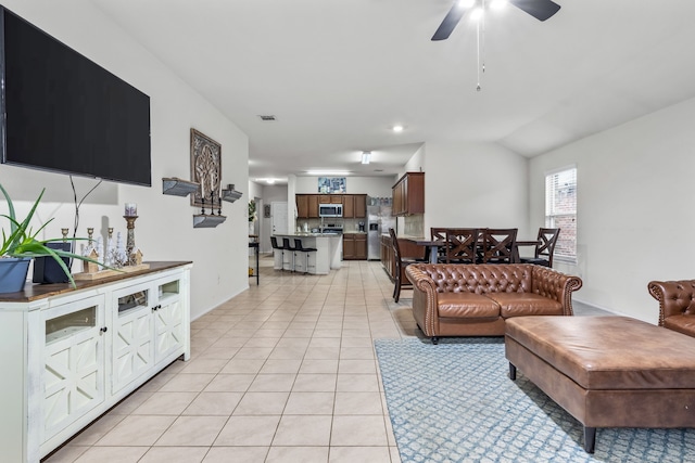 2260 Torch Lake Dr, Forney, TX 75126 - living room with baseboards, visible vents, lofted ceiling, a ceiling fan, and light tile patterned floors
