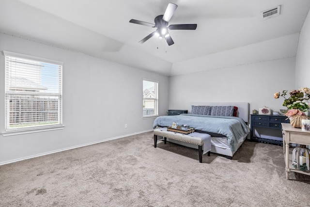 bedroom with ceiling fan, vaulted ceiling, and carpet