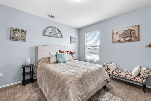 bedroom with carpet floors, visible vents, and baseboards