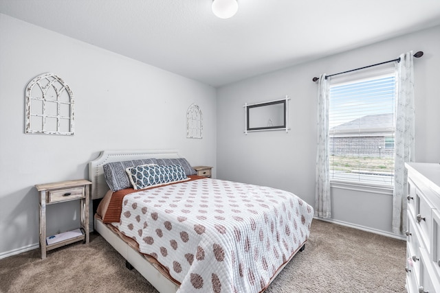 bedroom featuring carpet floors and baseboards