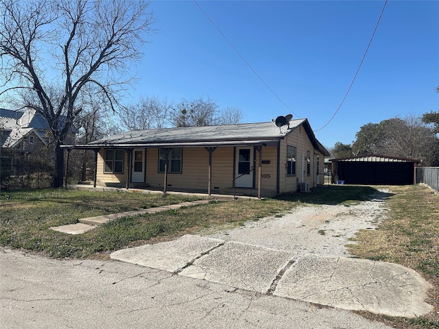 view of front of property featuring a carport and central AC unit