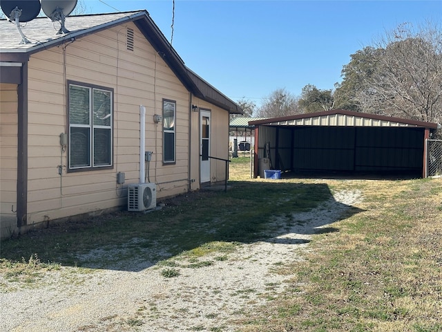 view of home's exterior featuring a carport, ac unit, and a lawn