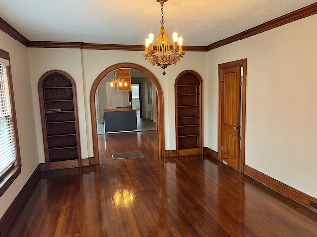 unfurnished dining area featuring a notable chandelier, built in features, dark hardwood / wood-style floors, and a healthy amount of sunlight