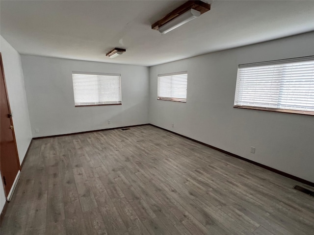 empty room with hardwood / wood-style floors