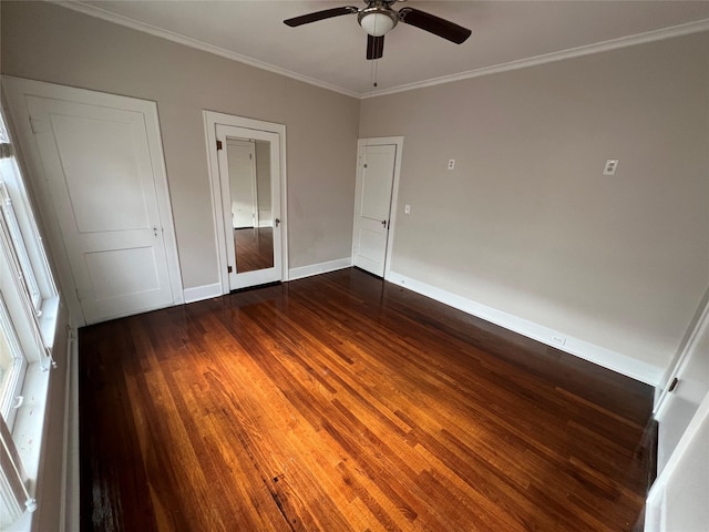 unfurnished bedroom with ornamental molding, ceiling fan, and dark hardwood / wood-style flooring