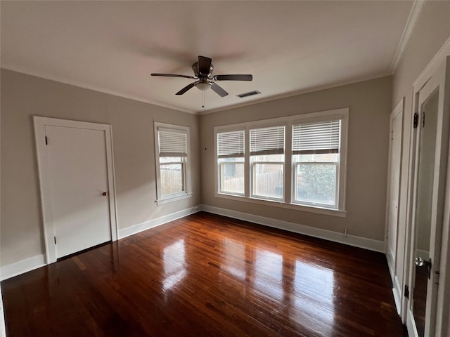 unfurnished bedroom featuring ornamental molding, ceiling fan, and dark hardwood / wood-style flooring