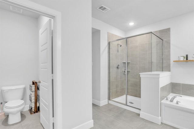 bathroom featuring plus walk in shower, tile patterned floors, and toilet