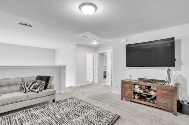 living room featuring light carpet and a textured ceiling