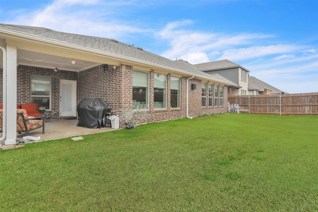 rear view of property with a patio area and a lawn