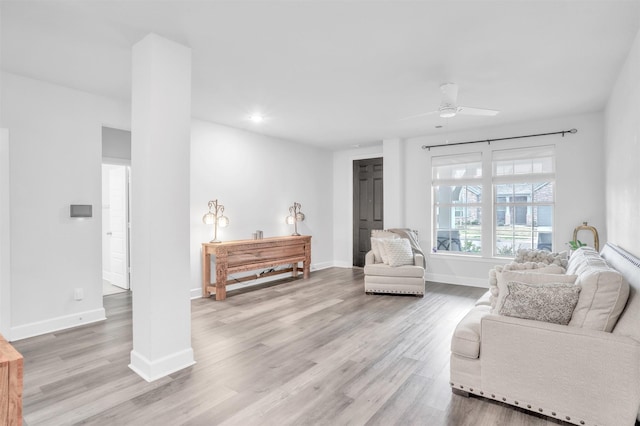 living room with ceiling fan and light hardwood / wood-style floors