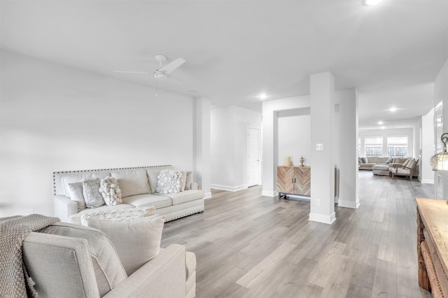 living room featuring ceiling fan and light wood-type flooring