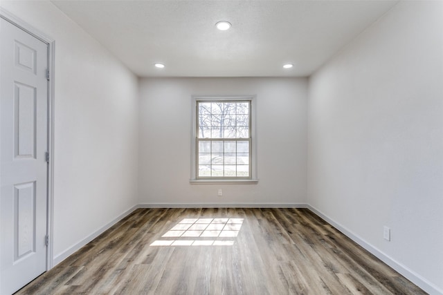 empty room with dark hardwood / wood-style flooring