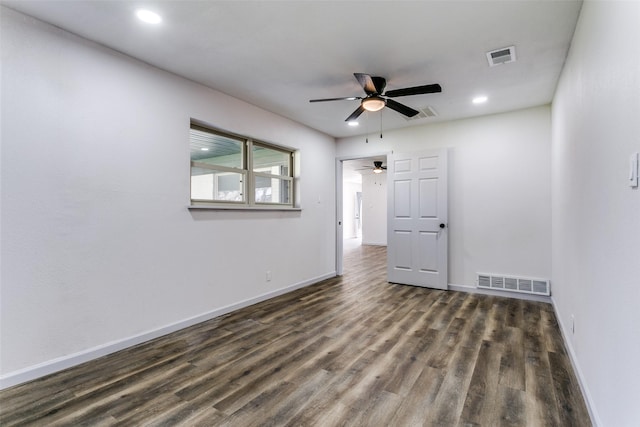 unfurnished room with ceiling fan and dark hardwood / wood-style flooring