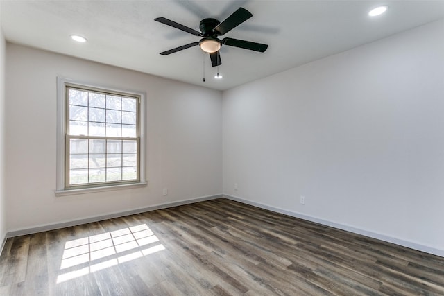 empty room featuring dark wood-type flooring and ceiling fan