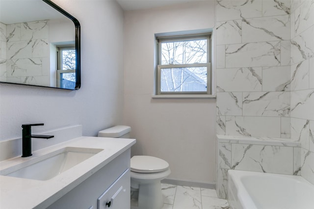 bathroom featuring vanity, a bath, and toilet